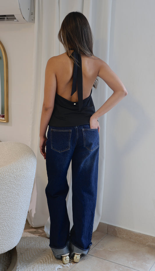 Woman wearing black top with jeans